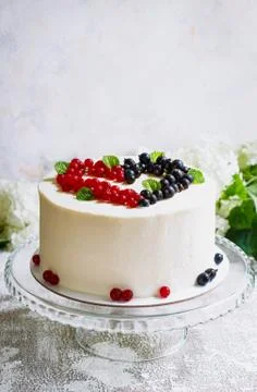 Round white cake with berries in the form of hearts, Valentine's Day, on whit Stock Photos