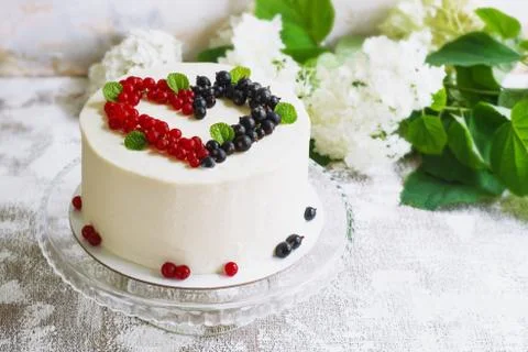 Round white cake with berries in the form of hearts, Valentine's Day, on whit Stock Photos