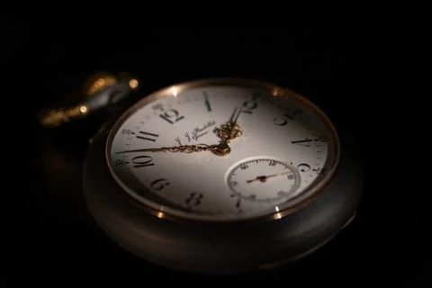 Round white dial of an antique clock with golden second, minute and hour hands Stock Photos