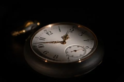 Round white dial of an antique clock with golden second, minute and hour hands Stock Photos