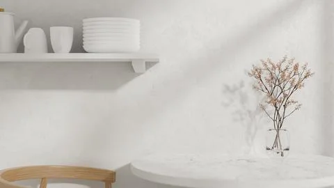 A round white dining table with a vase, a wooden armchair, and a wall shelf.. Stock Photos