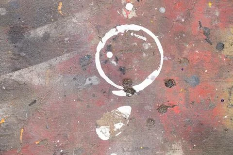 Round white mark from a standing can on a multi-colored board in a paint shop Stock Photos