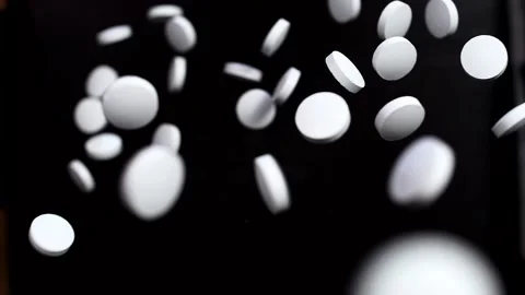 Round white pills on a black background. Stock Footage 141184673