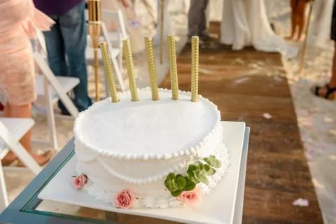 Round white wedding cake with patterns and salutes. Stock Photos