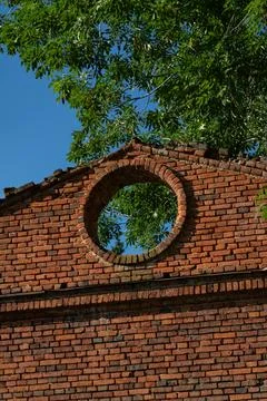 A round window in a brick building. 19th century buildings Stock Photos