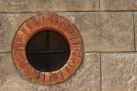 Round Window with Brick Frame and Iron Security Bars - Liguria Italy Foto stock