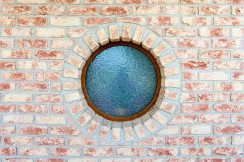 Round window on brick wall Stock Photos