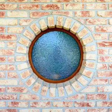 Round window on brick wall Stock Photos