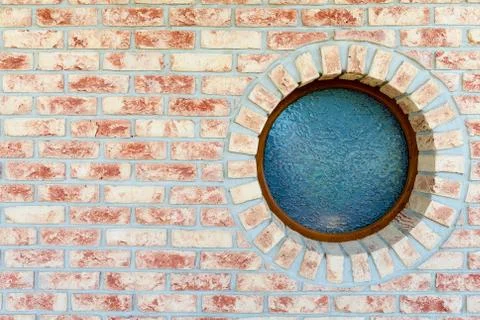 Round window on brick wall Stock Photos