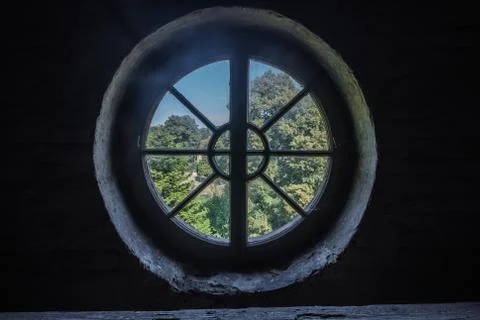 Round window in a dark room from a monastery Stock Photos