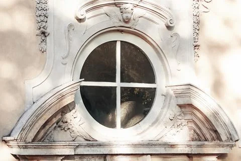 Round window decorated with stucco close up Stock Photos