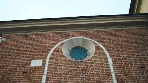 Round Window with Iron Grille on Brick Wall Stock Footage 307836694