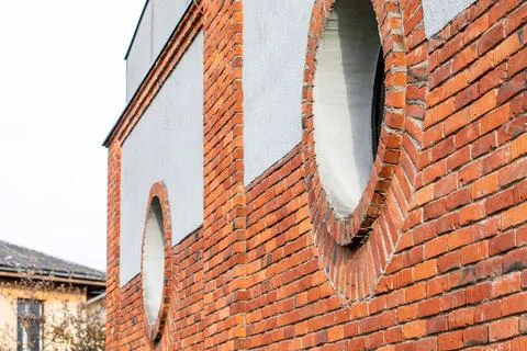 Round window. Red brick wall and light plaster Stock Photos