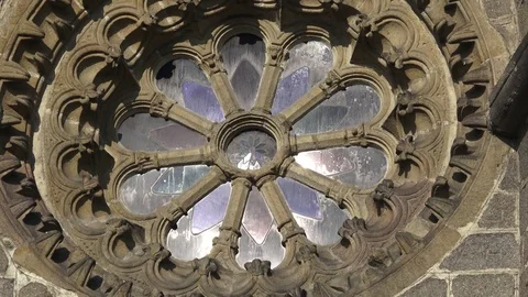 Round Window. Round window with stained glass on facade of the building. Stock Footage 94565664