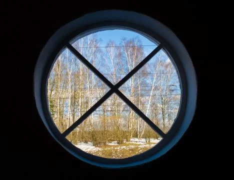 Round window with a view of the trees Stock Photos