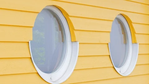 Round window on wooden surface, beach house Stock Footage 108511512