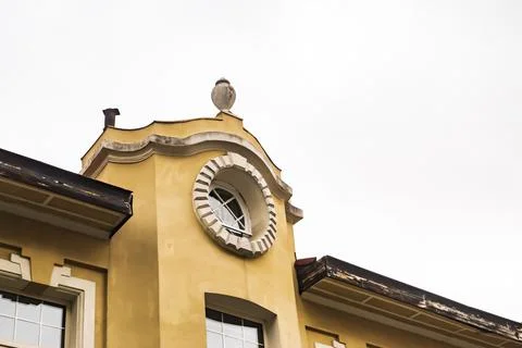 Round window on yellow facade 스톡 사진