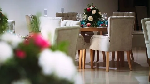 Round wooden table around which there are chairs and in the interior of the Stock Footage 97721326