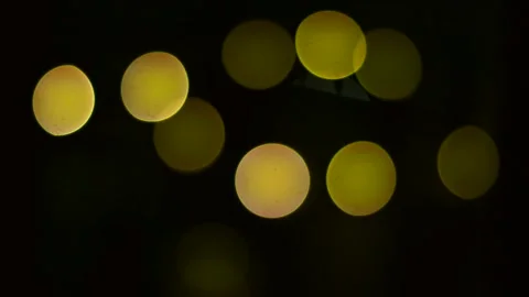 Round yellow bokeh with a temporary transition to blue. Stock Footage 236418058
