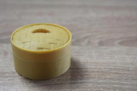 Round yellow box on a light background Stock Photos