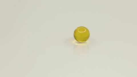 Round yellow capsules roll on white table, nutritional supplements, vitamins Stock Footage 147978875