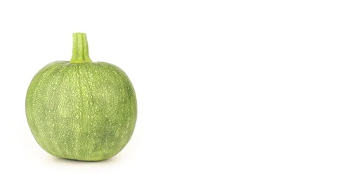Round zucchini rotates back and forth on a white background with copy space Stock Footage 222002773