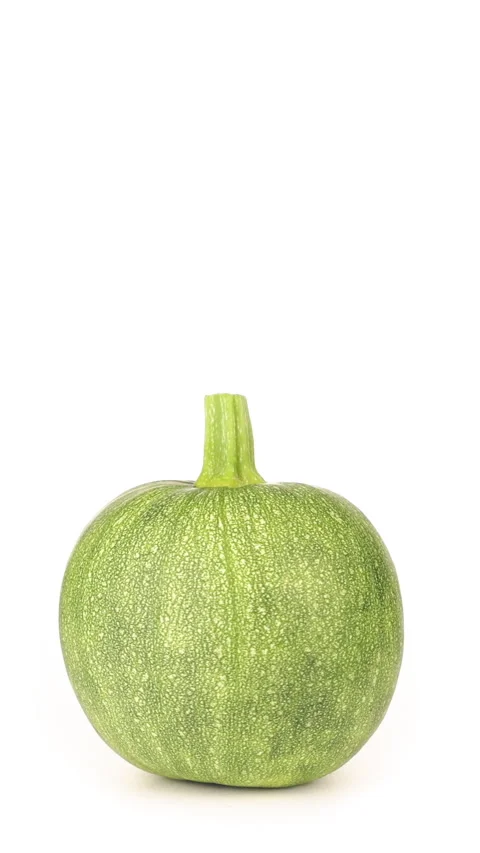 Round zucchini rotates on white background. Vertical video for social media Stock Footage 222964222