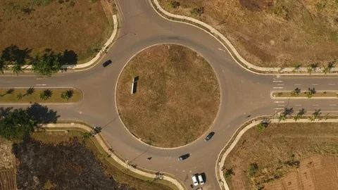 Roundabout In The Afternoon With Motorbikes and Cars Passing By Stock Footage