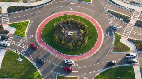 Roundabout intersection on American road with driving cars. High angle view of Stock Footage 319056537