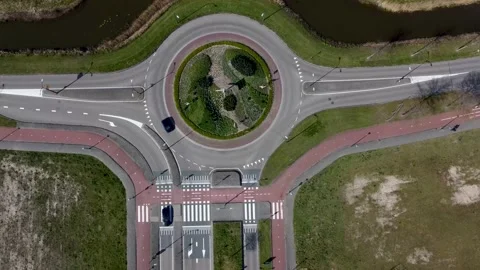 Roundabout at the intersection of two asphalted gray country roads Stock Footage 218578568