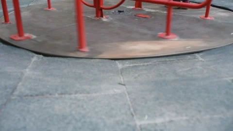Roundabout merry go round spinning on empty playground with its shadow, red Stock Footage 134154305