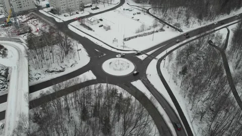 Roundabout with Traffic during winter covered with snow, Aerial Rising 스톡 동영상 150106806
