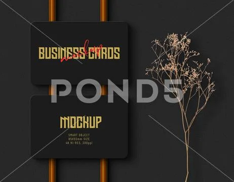 Rounded business cards on copper rods on rough concrete sheet 4k psd mockup PSD Template