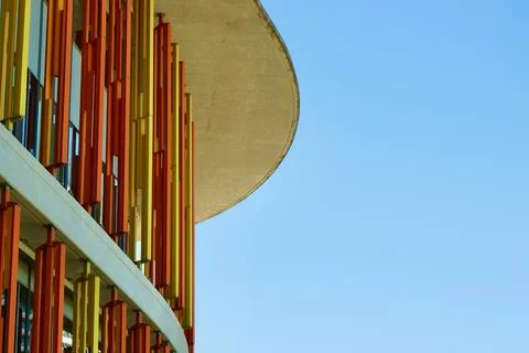 Rounded corner of a modern building with lined architectural elements Stock Photos