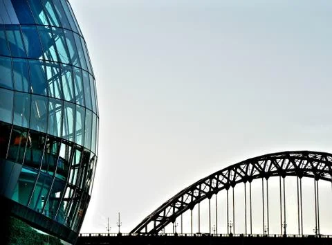 Rounded glass building and tyne bridge Fotos de archivo