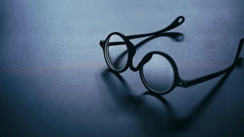 Rounded glasses drop on black desk, failure of business concept Stock Footage 120817066
