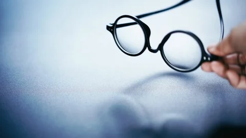 Rounded glasses picked up from black desk, start of business concept Stock Footage 120817064