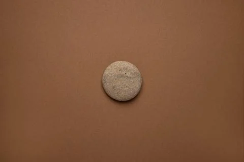 Rounded gray striped stone on brown background , trend minimal style Stock Photos