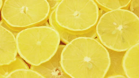 Rounded Lemon Slices Rotating, Yellow Food Background Stock Footage 117113838