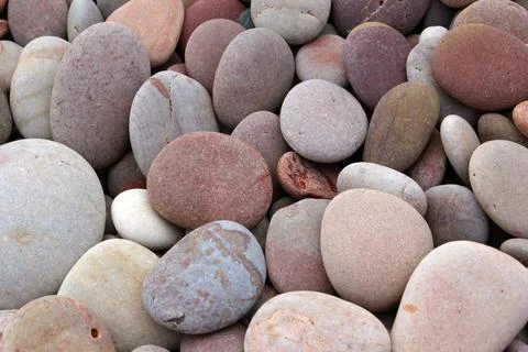 Rounded pebbles at the beach Stock Photos