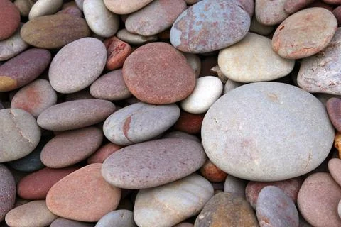 Rounded pebbles at the beach Stock Photos