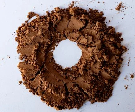 Rounded shape of bitter cocoa powder on white background. Copy space Stock Photos