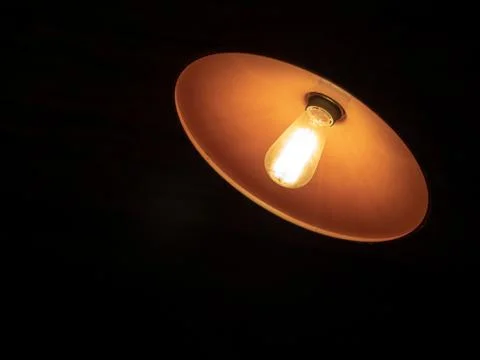 Rounded shape lamp shining in the dark. Stock Photos