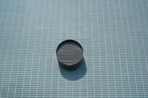 Rounded ventilation on blue brick wall Stock Photos
