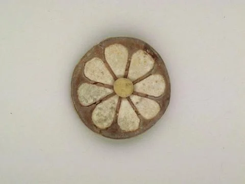 Roundel with daisy pattern. Roundel with daisy pattern. Clay, glazed. Gold .. Stock Photos