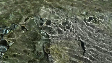 Roundish moving shadows on the ground of a mountain stream (slow motion) 스톡 동영상 260842966