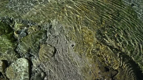 Roundish sunlight effects on the riverbed of a mountain stream 스톡 동영상 260842452