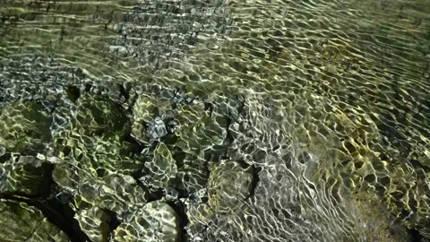 Roundish sunlight effects on the riverbed of a mountain stream 스톡 동영상 260842595