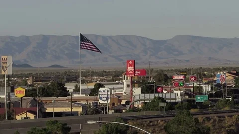Route 66 Highway business district bird's eye view with US Flag in Kingman AZ Stock Footage
