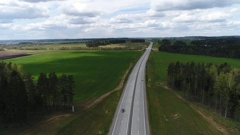 Route and beautiful green fields surrounding, aerial shot Video stock 86156968